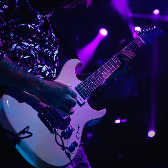 A guitarist playing rock music on a stage